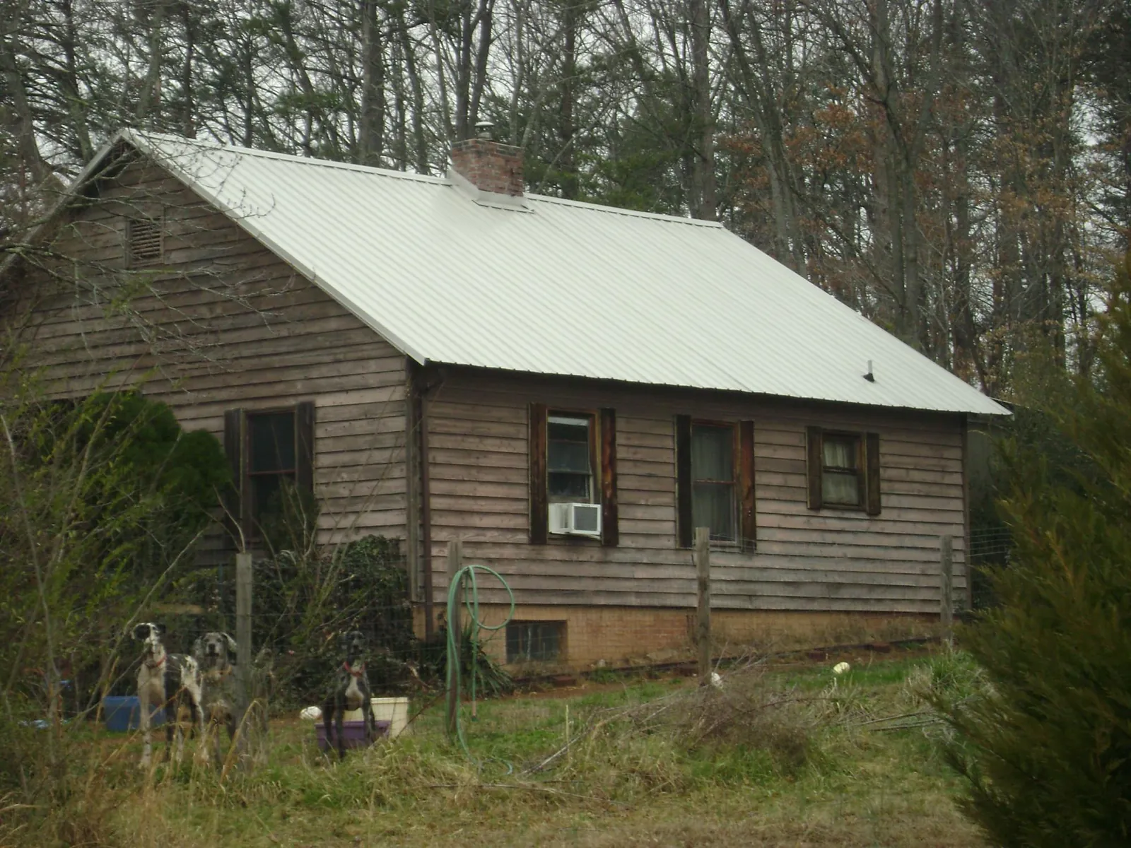 White metal roof on an old wood sided farmhouse, from a Metal Roof Installation job in Herrin
